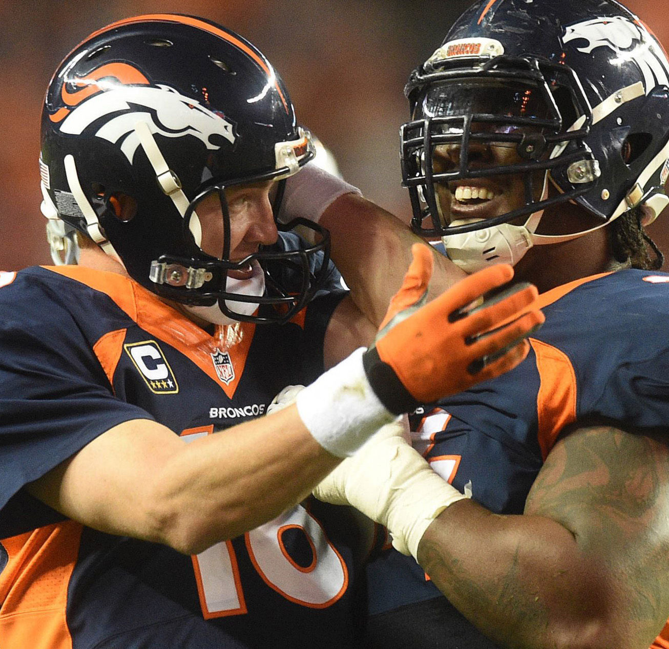 Broncos quarterback Peyton Manning celebrates the 509th touchdown of his career, breaking the NFL record. Manning threw the pass in the 2nd quarter of a game against the San Francisco 49ers to wide receiver Demaryius Thomas on Sunday, October 19, 2014. He is being congratulated by Broncos Guard Orlando Franklin. (The Gazette/Jerilee Bennett)